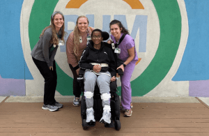 Student, Christy Moore, with traumatic brain injury with 3 nurses